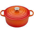 An orange / flame colored 5-1/2 Le Creuset Signature Enameled Cast Iron Round French Dutch Oven