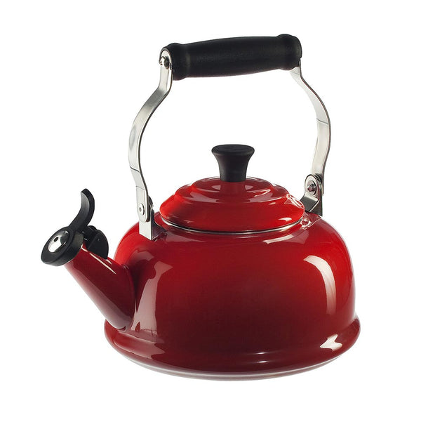 A cerise/ red colored Le Creuset Enameled Steel 1.7 Quart Classic Whistling Tea Kettle